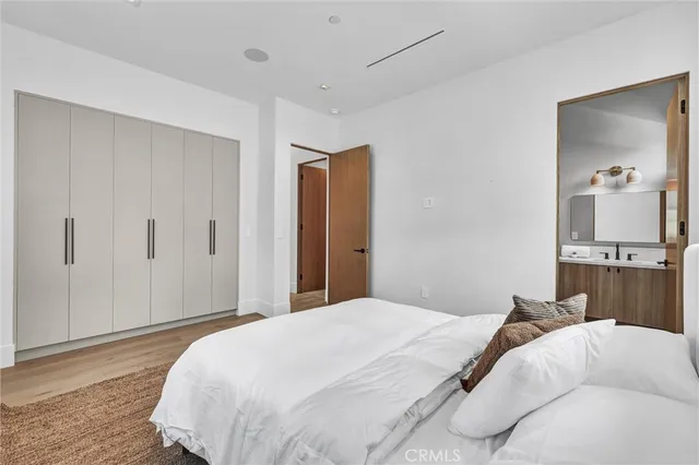 a bedroom with a bed and a mirror