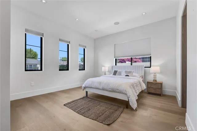 a bedroom with a bed lamp and a window