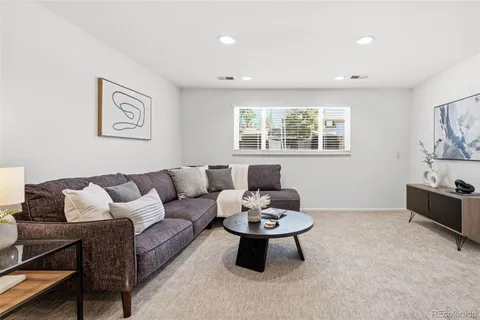 a living room with furniture a window and a table