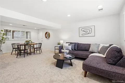 a living room with furniture and view of kitchen