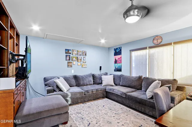 a living room with furniture and a large window