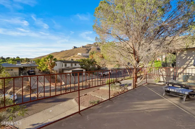 a view of a pathway with a wrought fence