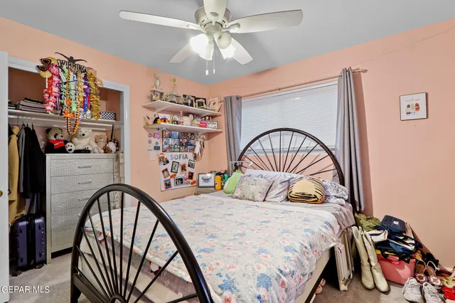 a bedroom with a bed and a large window