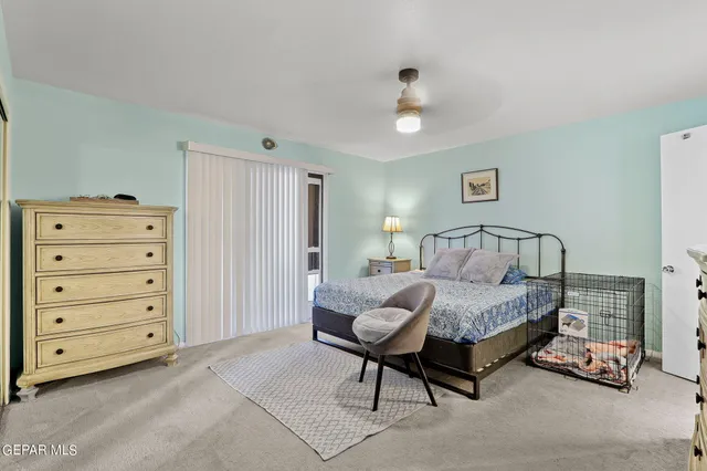 a spacious bedroom with a bed and a dresser