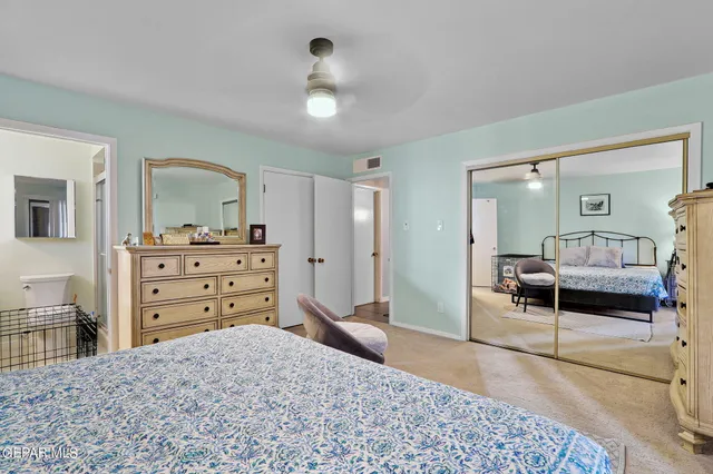 a bedroom with a bed and a dresser