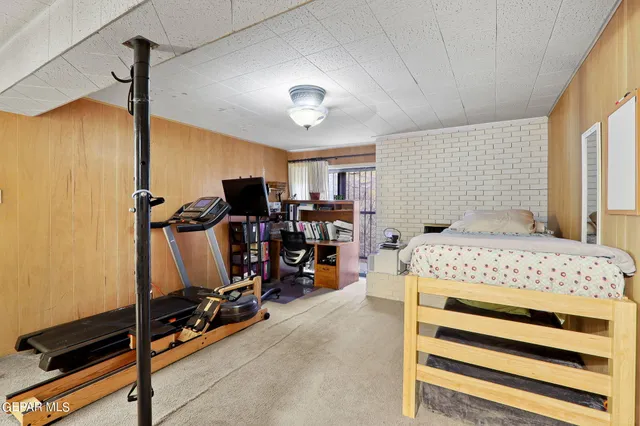 a bedroom with a bed and a flat tv screen