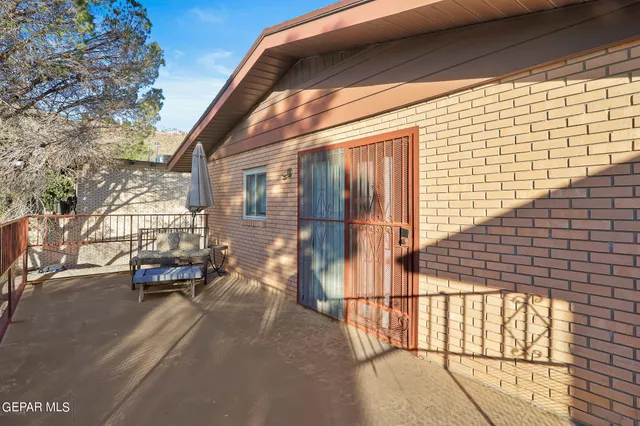 a view of a balcony with car parked on the road