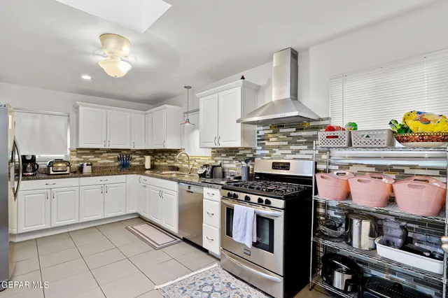 a kitchen with a stove and cabinets