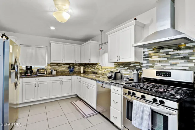 a kitchen with cabinets and appliances