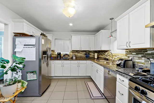 a kitchen with a sink stainless steel appliances and cabinets