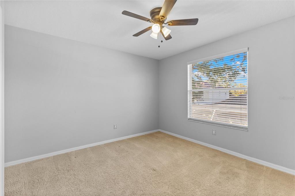 1422 Trail Boss Lane Brandon, FL 33511 - Photo 23 of 31 an empty room with a window and a fan