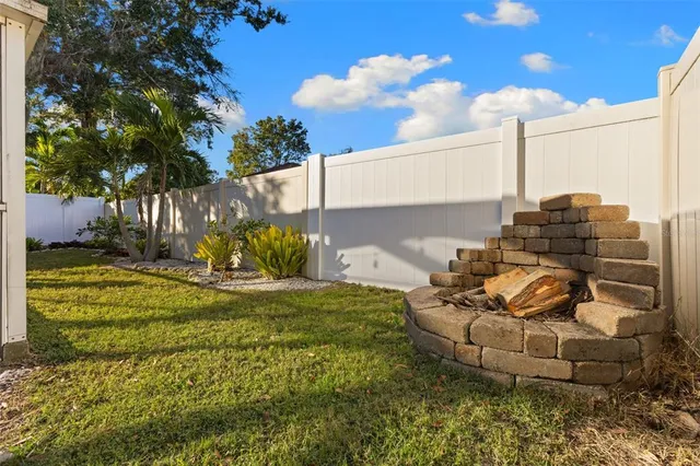a view of a garden with chair and tables