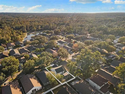 an aerial view of residential houses with city view