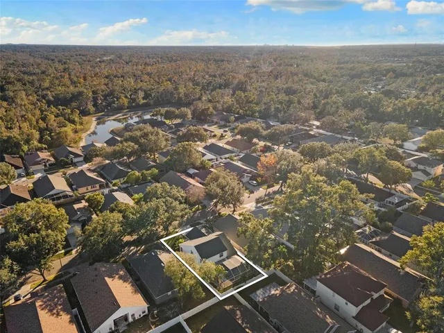 an aerial view of residential houses with city view