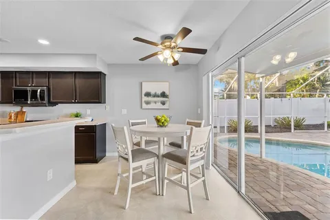 a dining room with furniture a flat screen tv and outdoor view
