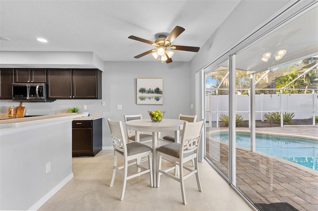 1422 Trail Boss Lane Brandon, FL 33511 - Photo 9 of 31 a dining room with furniture a flat screen tv and outdoor view