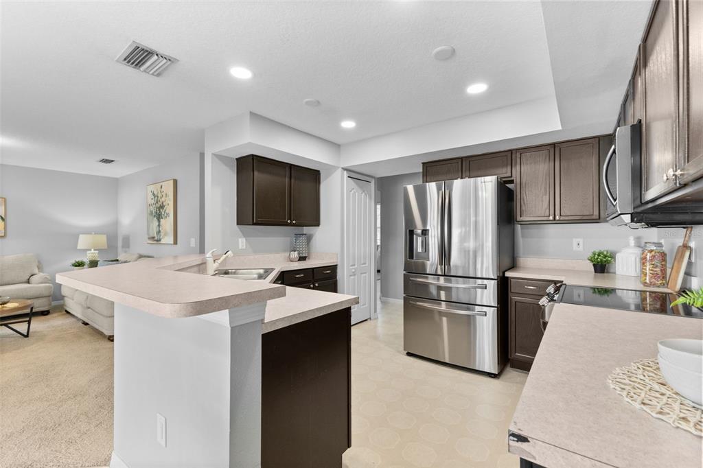 1422 Trail Boss Lane Brandon, FL 33511 - Photo 10 of 31 a kitchen with a sink stainless steel appliances and white cabinets