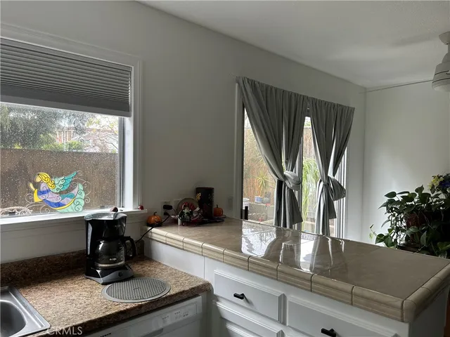 a room with painting on the wall and a potted plant