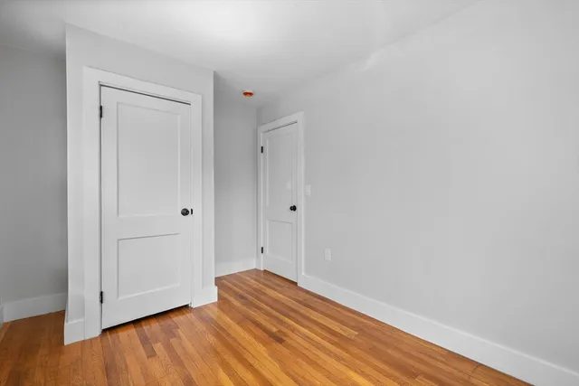 a view of room with wooden floor