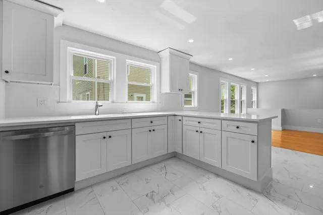 a kitchen with sink attached with living room