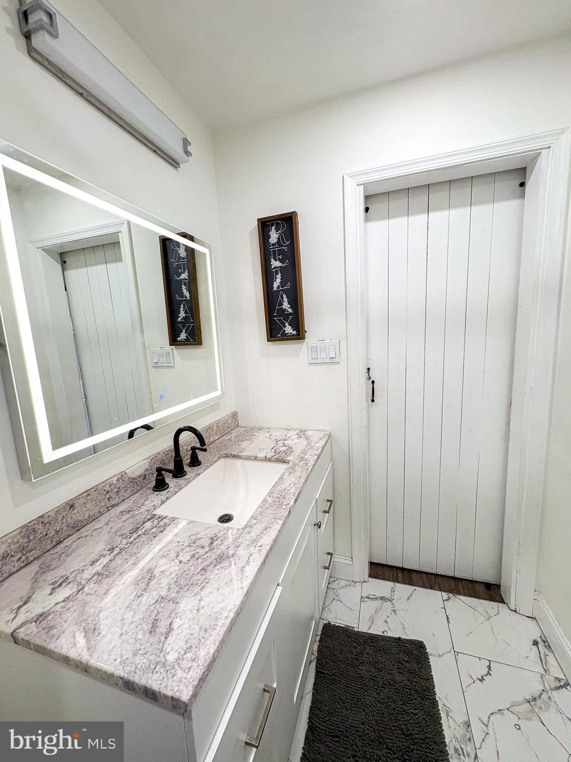750 Miller Drive Dover, DE 19901 - Photo 12 of 49 a bathroom with a sink and a mirror