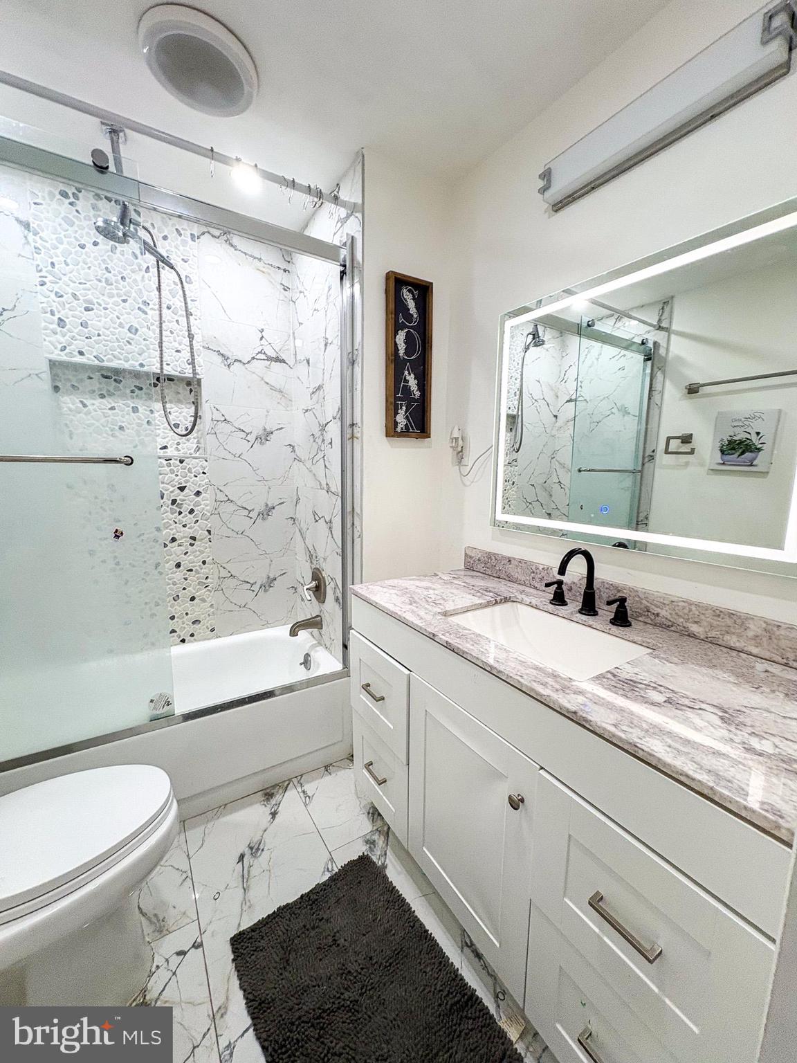 750 Miller Drive Dover, DE 19901 - Photo 14 of 49 a bathroom with a granite countertop sink a toilet and shower