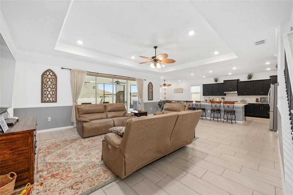 7208 Southwest 65th Place Road Ocala, FL 34474 - Photo 15 of 76 a living room with furniture and a flat screen tv