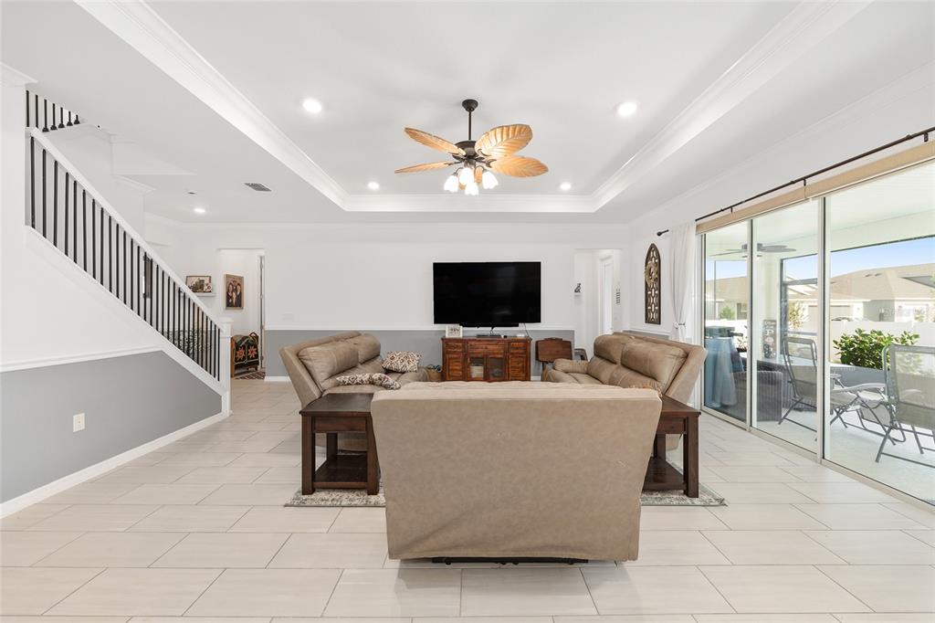 7208 Southwest 65th Place Road Ocala, FL 34474 - Photo 17 of 76 a living room with furniture and a flat screen tv