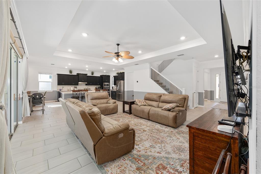 7208 Southwest 65th Place Road Ocala, FL 34474 - Photo 19 of 76 a living room with furniture and a flat screen tv