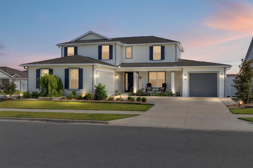 7208 Southwest 65th Place Road Ocala, FL 34474 - Photo 2 of 76 a front view of a house with a yard and garage
