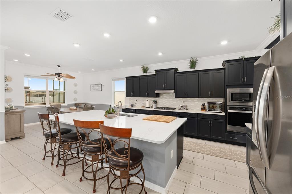7208 Southwest 65th Place Road Ocala, FL 34474 - Photo 25 of 76 a large kitchen with a table and chairs