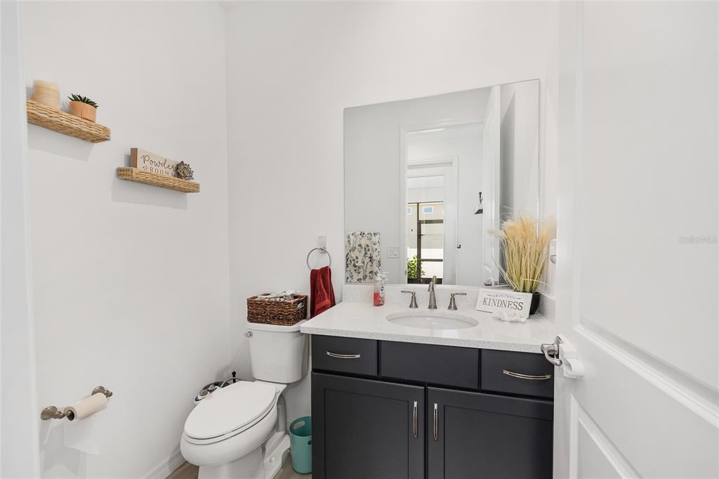 7208 Southwest 65th Place Road Ocala, FL 34474 - Photo 32 of 76 a bathroom with a sink a toilet and mirror