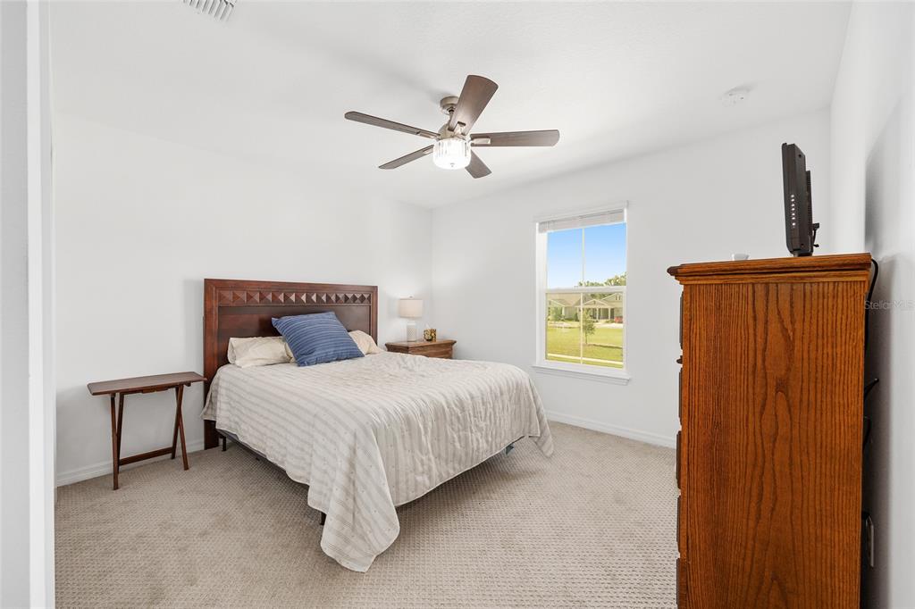 7208 Southwest 65th Place Road Ocala, FL 34474 - Photo 35 of 76 a bedroom with a bed and a window