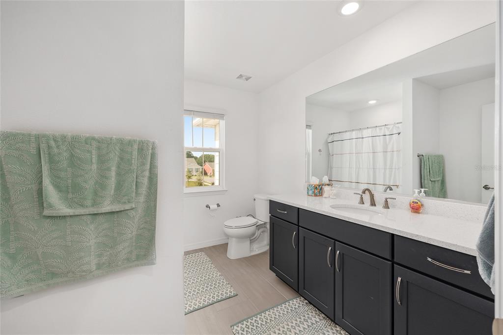 7208 Southwest 65th Place Road Ocala, FL 34474 - Photo 37 of 76 a bathroom with a double vanity sink mirror and toilet