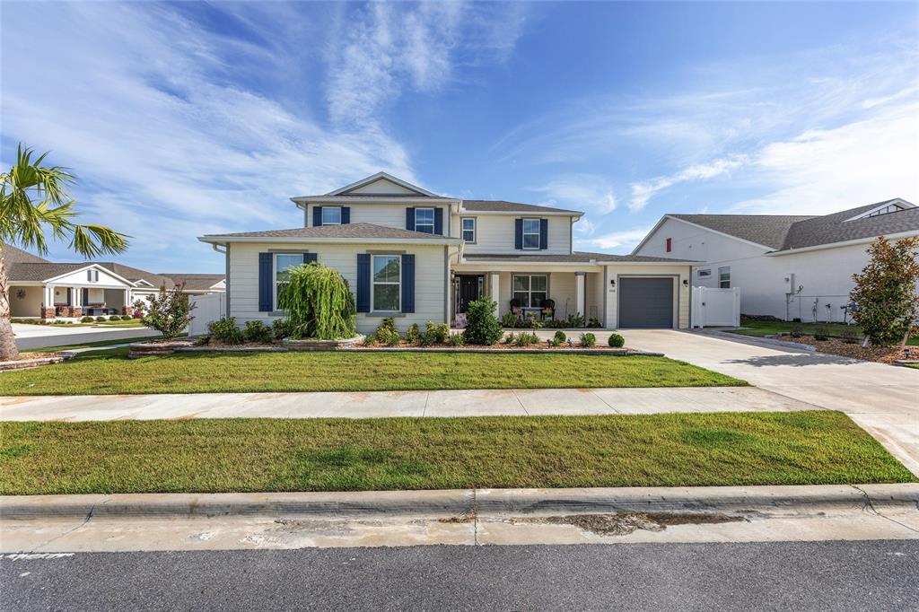 7208 Southwest 65th Place Road Ocala, FL 34474 - Photo 4 of 76 a front view of a house with a yard