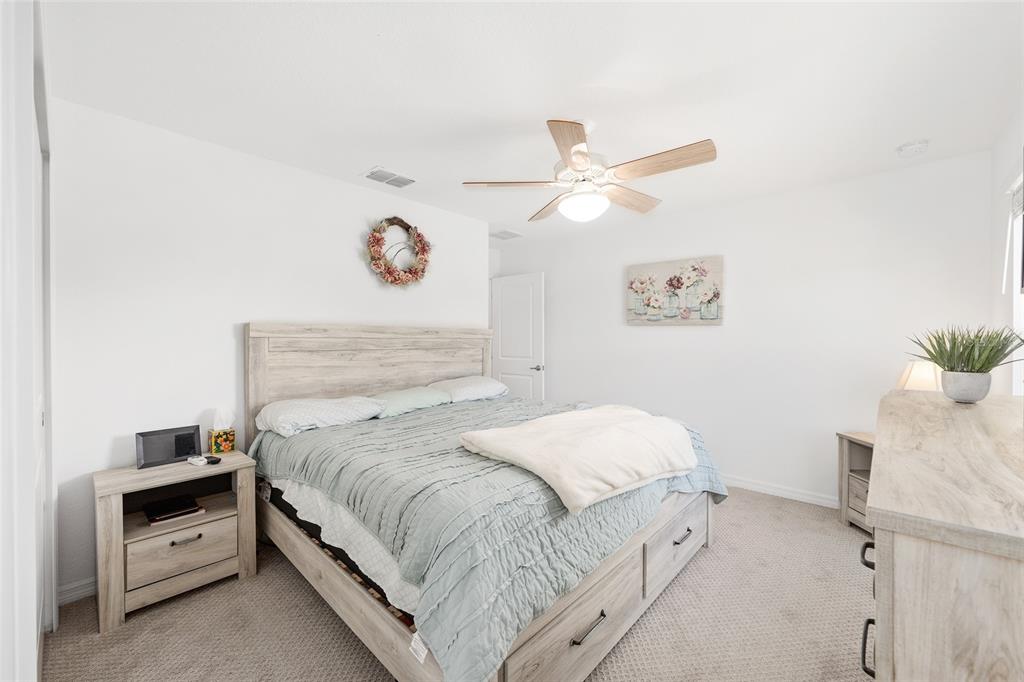 7208 Southwest 65th Place Road Ocala, FL 34474 - Photo 42 of 76 a bedroom with a bed and a chandelier