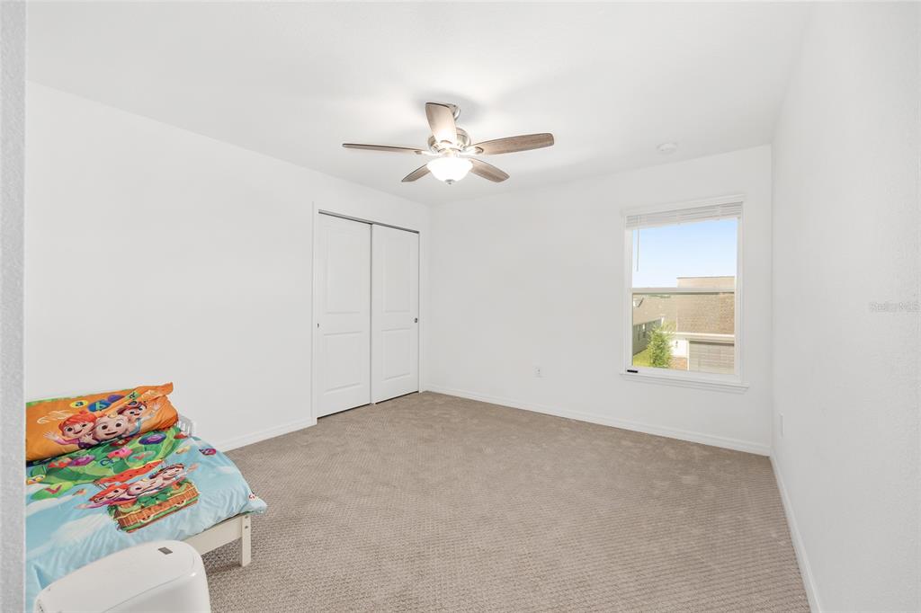 7208 Southwest 65th Place Road Ocala, FL 34474 - Photo 46 of 76 an empty room with a window and a ceiling fan