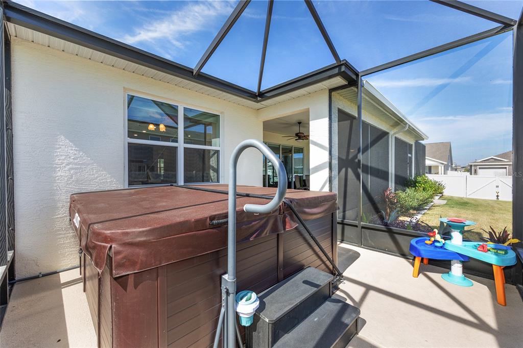 7208 Southwest 65th Place Road Ocala, FL 34474 - Photo 55 of 76 a table and chairs in a room next to a blue umbrella