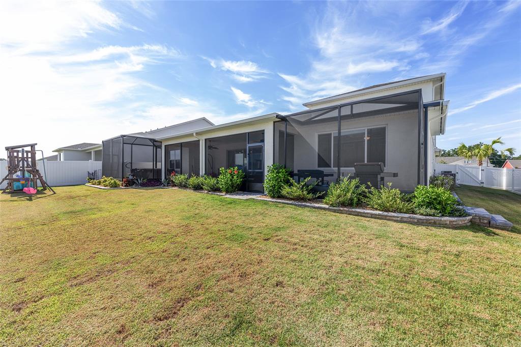 7208 Southwest 65th Place Road Ocala, FL 34474 - Photo 59 of 76 a view of a house with a yard