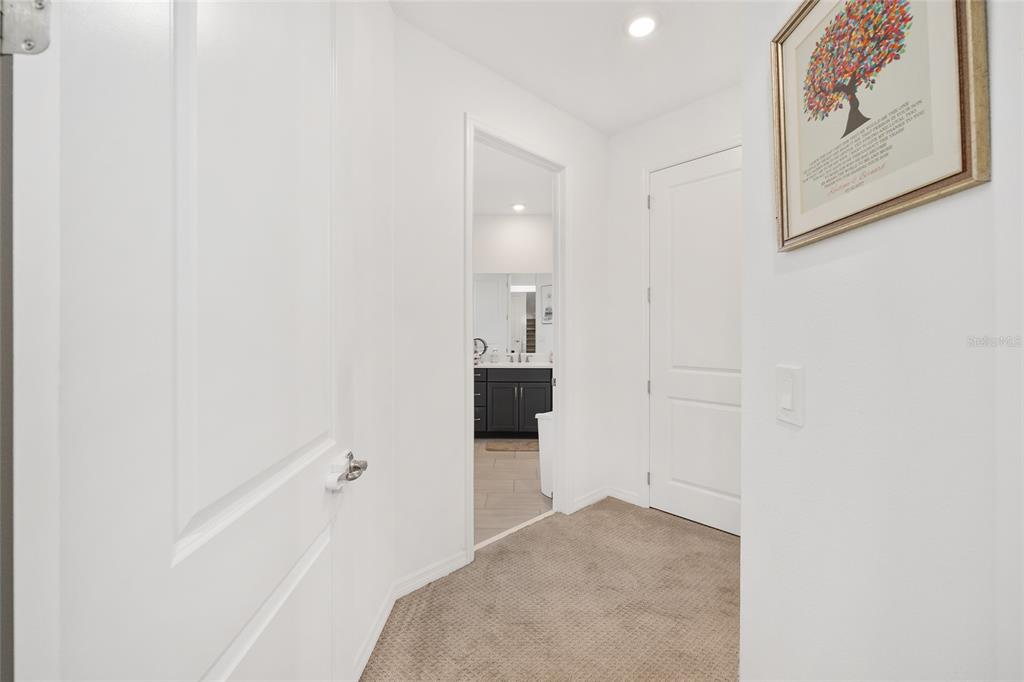 7208 Southwest 65th Place Road Ocala, FL 34474 - Photo 7 of 76 a view of a hallway with wooden floor and cabinet