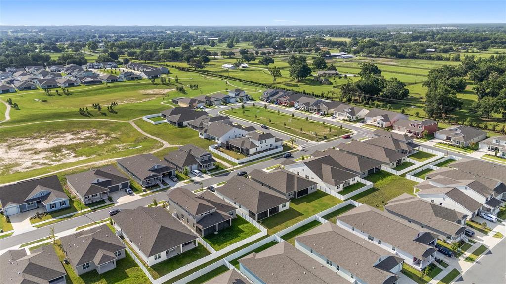 7208 Southwest 65th Place Road Ocala, FL 34474 - Photo 73 of 76 an aerial view of residential houses with outdoor space and ocean view
