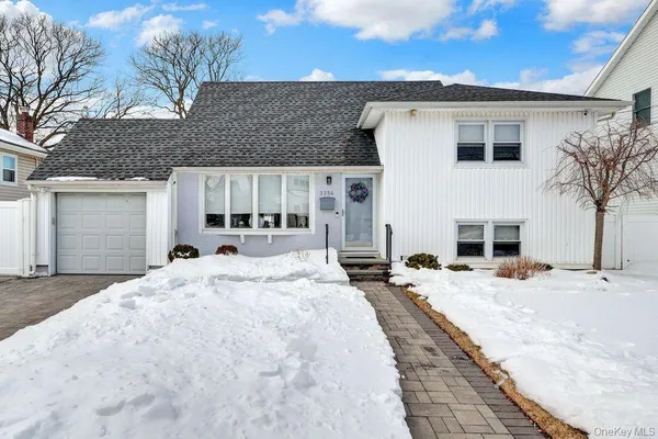 a view of house with garden space and swimming pool