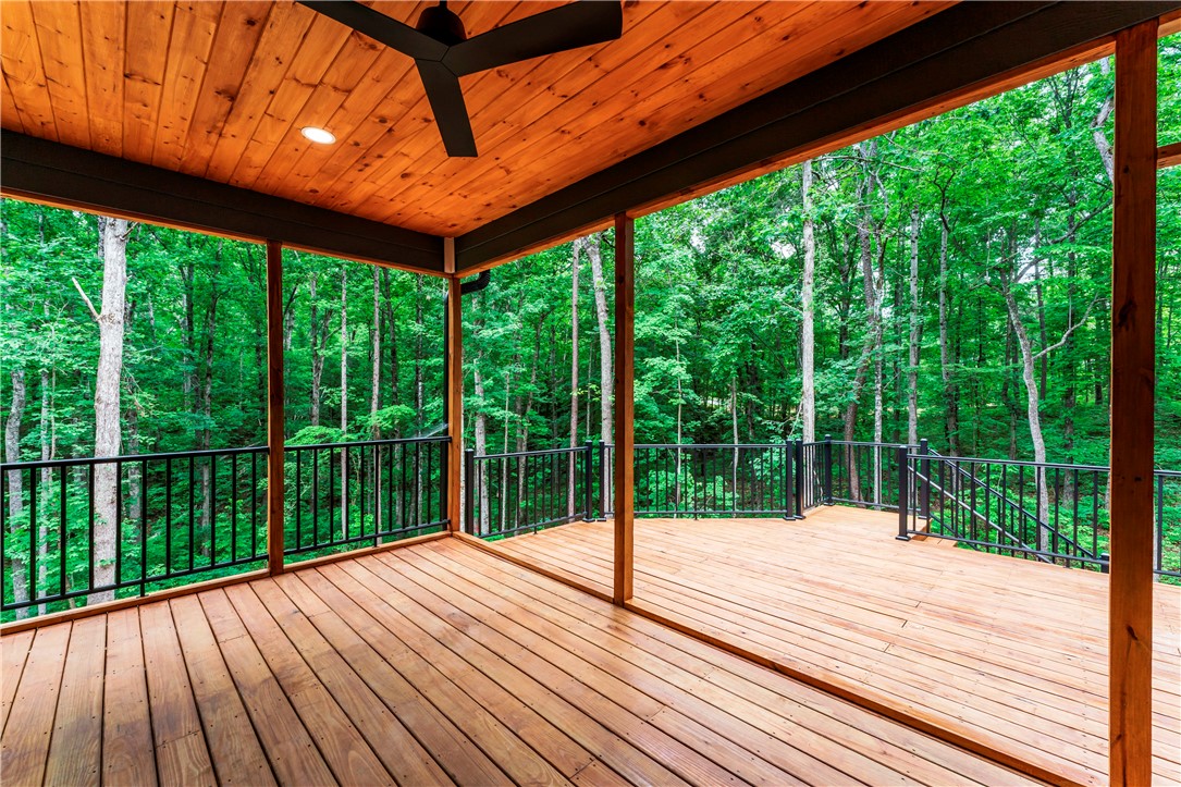 110 Gabriel Way Pickens, SC 29671 - Photo 32 of 48 A spacious wooden deck provides a serene outdoor living area, perfect for enjoying the peaceful wooded surroundings.