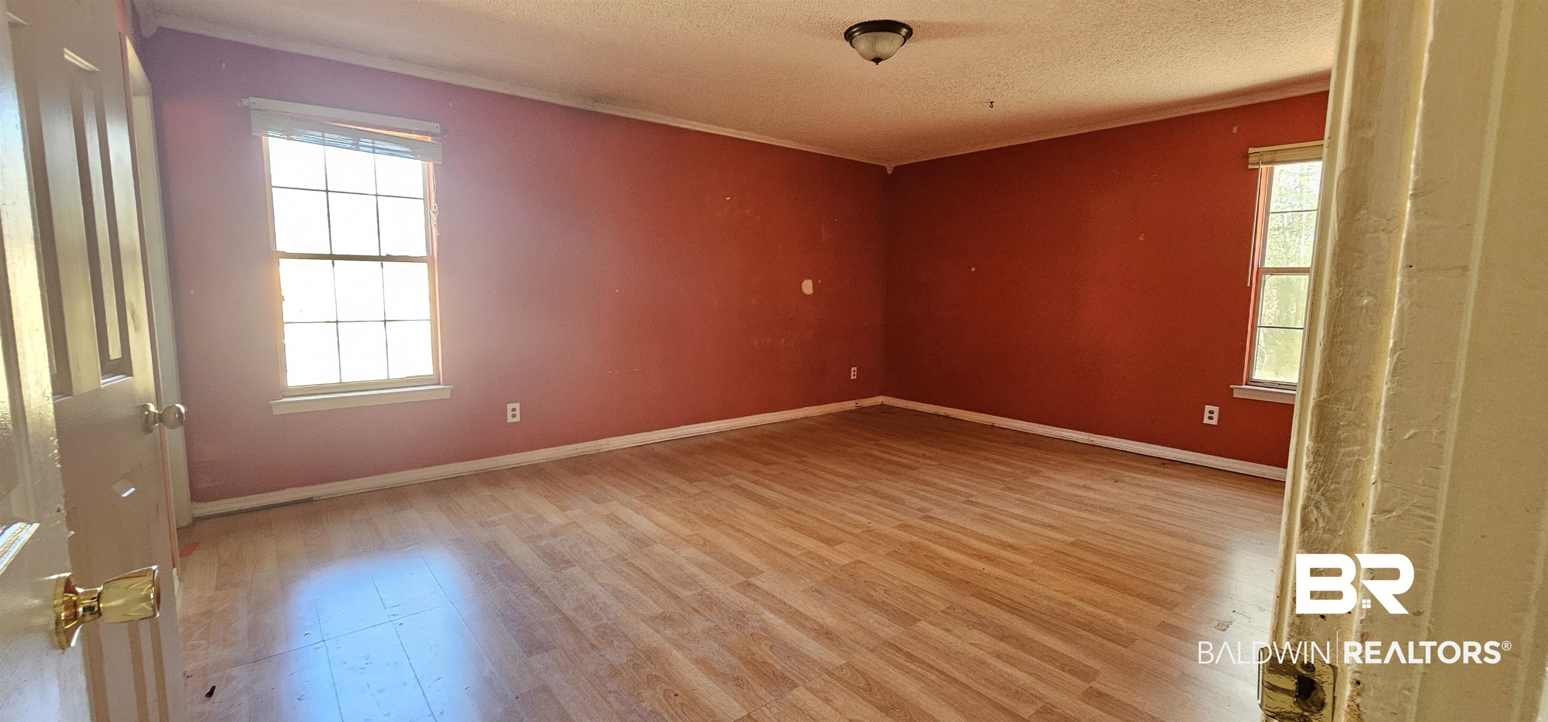 151 Bullard Street Atmore, AL 36502 - Photo 12 of 38 Spare room with light wood finished floors and a textured ceiling