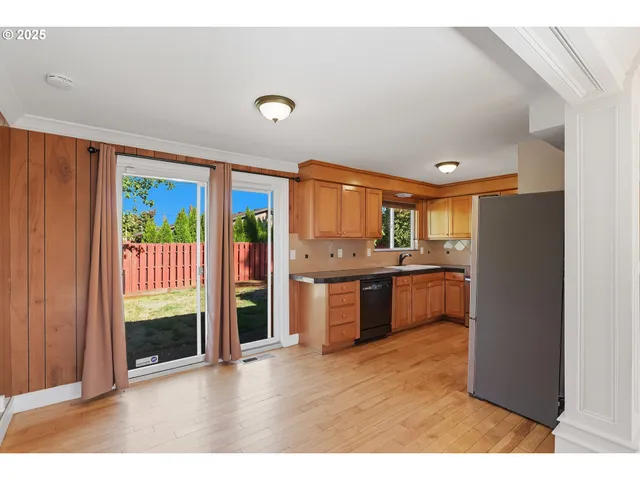 a kitchen with stainless steel appliances granite countertop a refrigerator and a sink