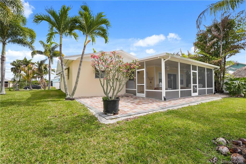1459 Southwest Seahawk Way Palm City, FL 34990 - Photo 6 of 11 a view of a house with backyard and sitting area