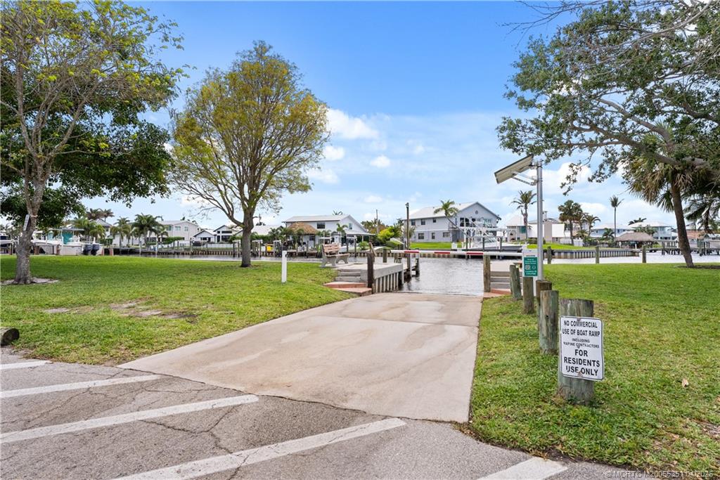 1459 Southwest Seahawk Way Palm City, FL 34990 - Photo 9 of 11 a park view with a bench plants and trees
