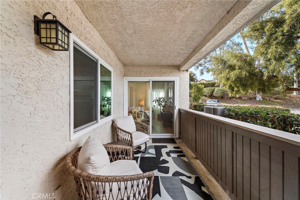 74 Corniche Drive, Unit D Dana Point, CA 92629 - Photo 14 of 22 a living room with patio furniture and garden