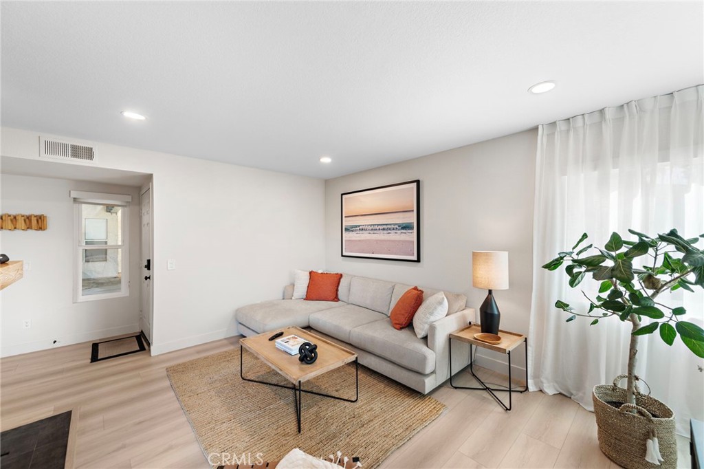 74 Corniche Drive, Unit D Dana Point, CA 92629 - Photo 3 of 22 a living room with furniture a potted plant and a window