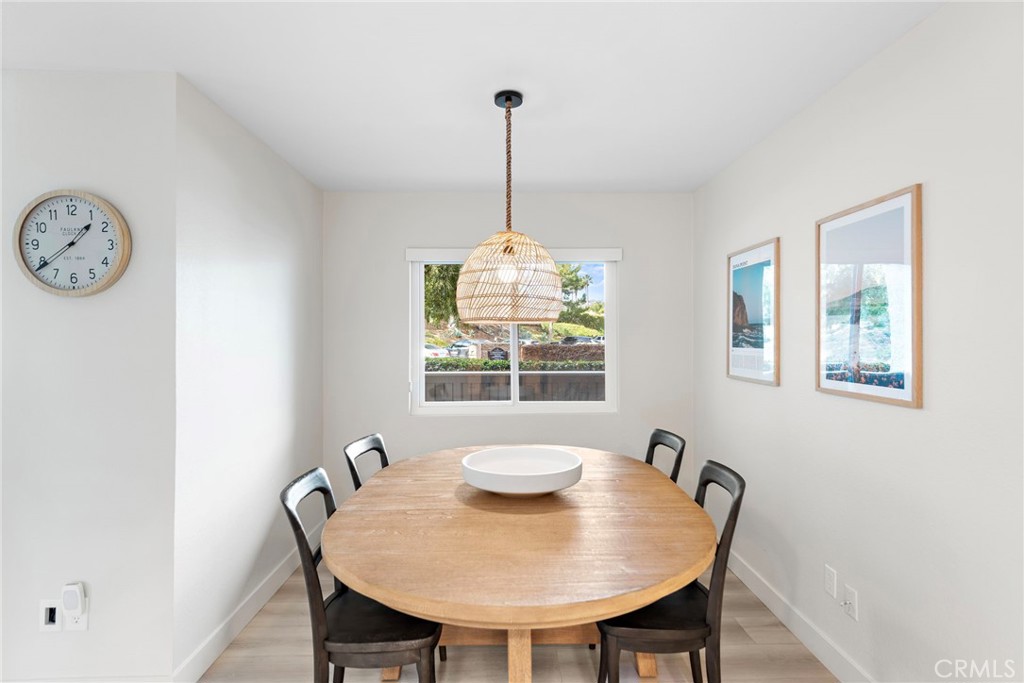 74 Corniche Drive, Unit D Dana Point, CA 92629 - Photo 5 of 22 a view of a dining room with furniture window and wooden floor